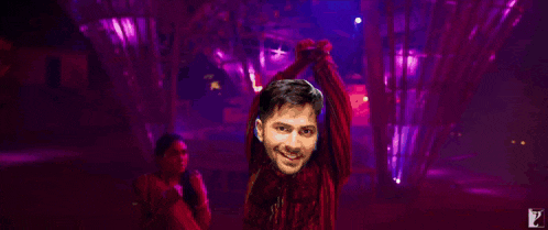 a man in a red shirt is standing in front of a purple background with the words is baar hit nhi mili toh