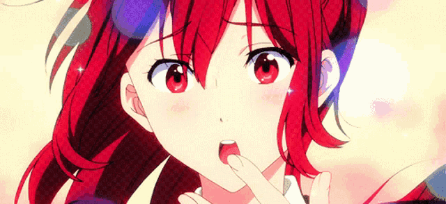 a close up of a girl with red hair and red eyes