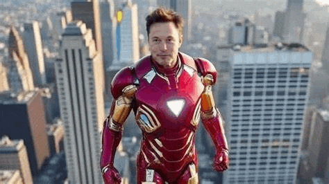 elon musk is wearing a red iron man suit and standing on top of a building .