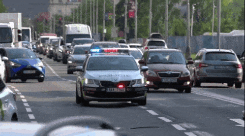 a police car is driving down a street