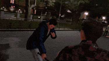 a man in a black jacket is holding a red lightning bolt