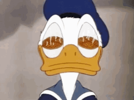 a close up of donald duck with his eyes closed