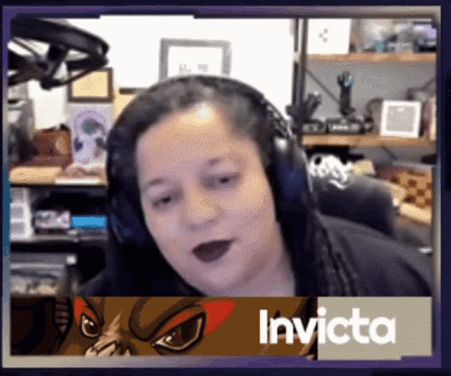 a woman wearing headphones with the name invicta on the bottom