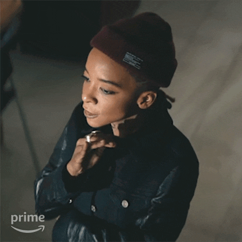 a woman wearing a beanie and a leather jacket has the word no on her face