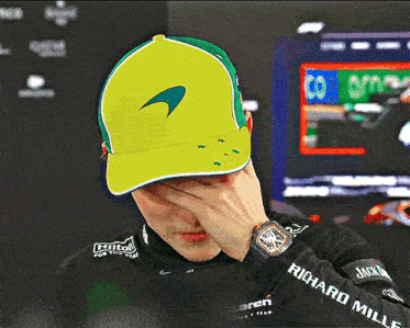a man wearing a richard mille watch covers his face