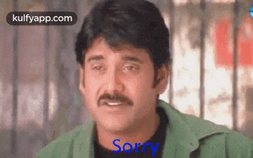 a man with a mustache is wearing a green jacket and says sorry .