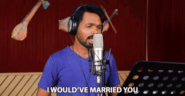 a man singing into a microphone with the words " i would 've married you " above him