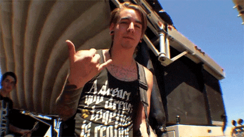 a man wearing a black tank top that says a dream your dreams together