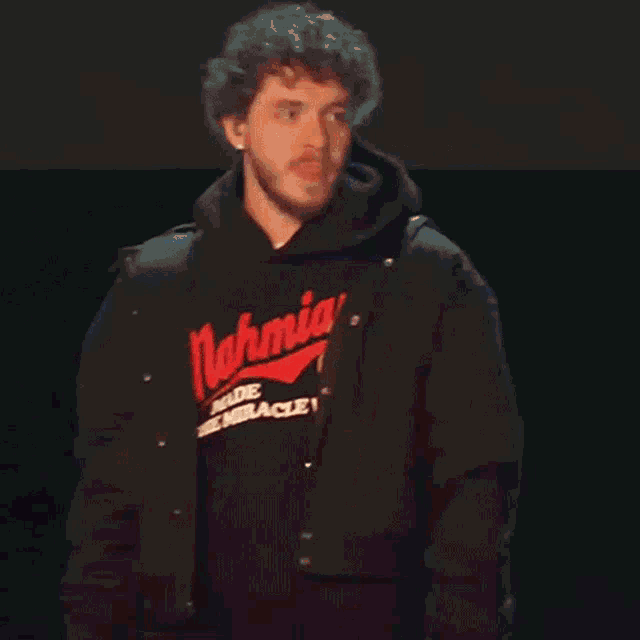 a man wearing a black shirt that says mahmia made the miracle v