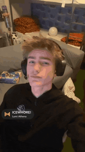 a young man wearing headphones with icewhore lumi athena written on the bottom of the screen