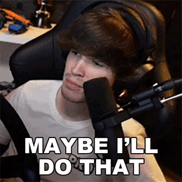 a man sitting in front of a microphone with the words maybe i 'll do that