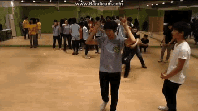 a group of people are dancing in a dance studio and the website www.bandicam.com is displayed