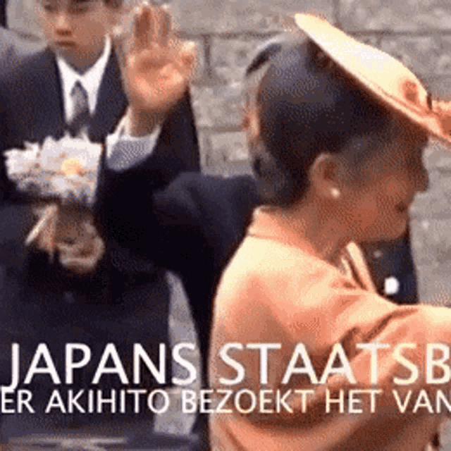 a woman in an orange hat is standing in front of a sign that says japans staatsb er akihito bezoekt het van