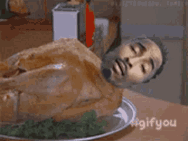 a turkey with a man 's face on it is on a plate .