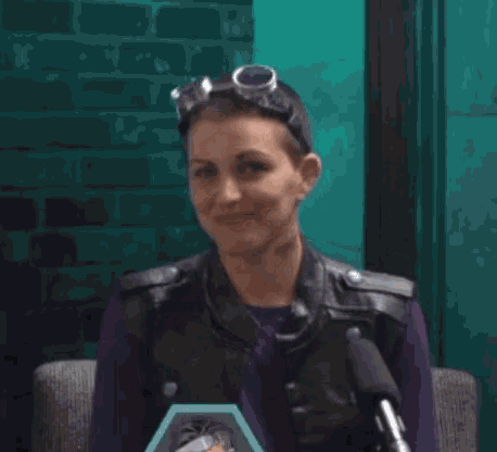a woman wearing goggles says i 'm so sorry in front of a microphone