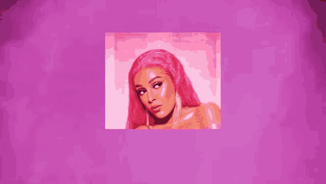 a close up of a woman with pink hair and earrings on a purple background .