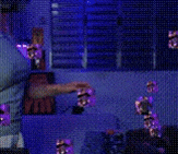 a woman in a blue shirt is standing in front of a window in a dark room .
