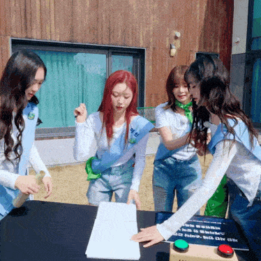 a group of girls are playing a game and one girl has a green sash that says ' eun ' on it