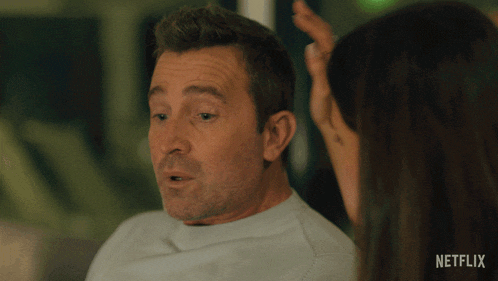 a woman touches a man 's head with the words no estoy bien above him