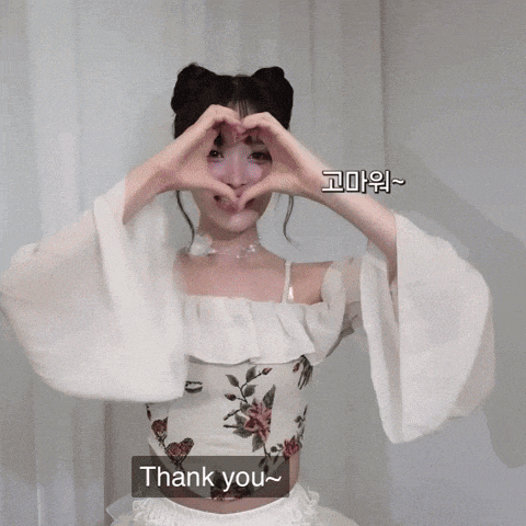 a woman is making a heart shape with her hands and the words " i love you " are below her
