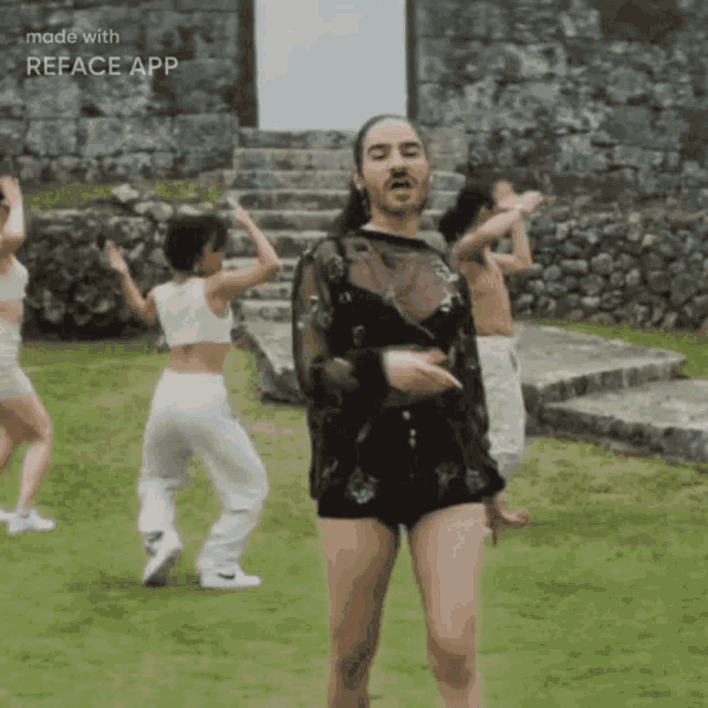 a group of people are dancing in a field with the words made with reface app in the corner