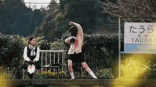 a girl is dancing in front of a sign that says taurabe