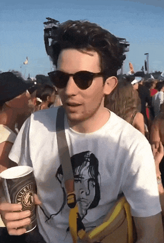 a man wearing sunglasses and a white t-shirt that says wallets