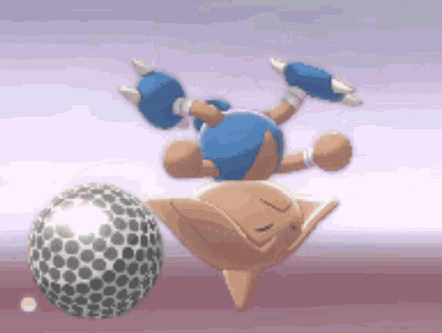 a cartoon character is balancing a silver ball on its head