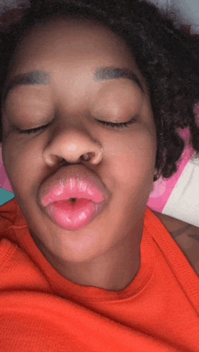 a close up of a woman 's face with her eyes closed and her mouth open