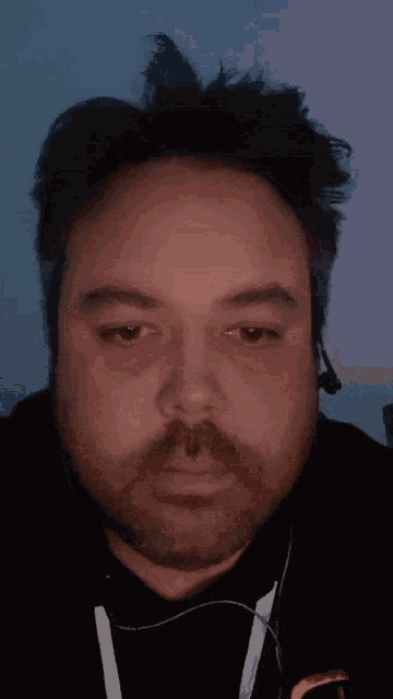 a close up of a man 's face with headphones on
