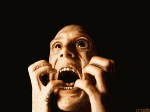 a close up of a man 's face with his mouth wide open