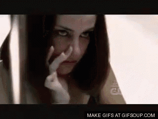 a woman is covering her nose with her hand and making a funny face .