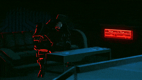 a dark room with a red light behind a table