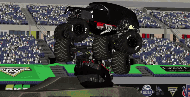 a monster truck is jumping over a ramp in front of a crowd at a monster jam