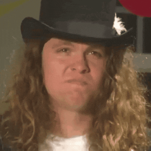 a man with long hair is wearing a top hat with a feather on it