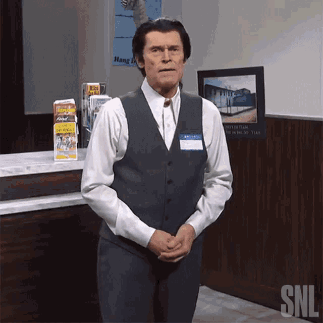 a man wearing a vest with a name tag that says " ariel "