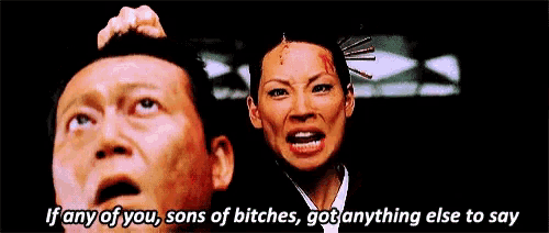 a man is holding a woman 's head and says if any of you sons of bitches got anything else to say ..