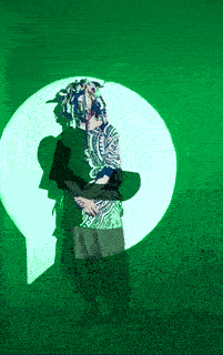 a person standing in front of a green light