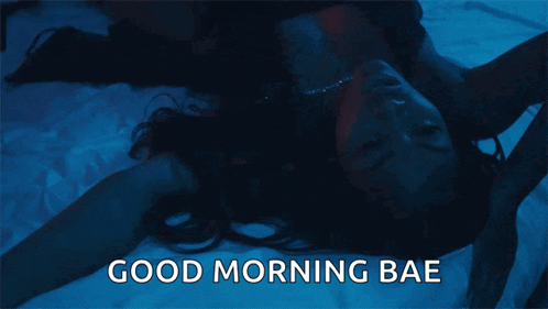 a woman is laying on a bed with the words good morning bae written on the bottom