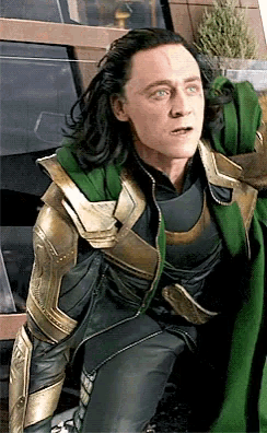 a man in a green and gold costume is kneeling down