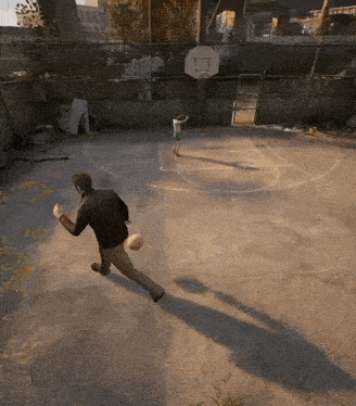 a man and a boy are playing basketball on a basketball court