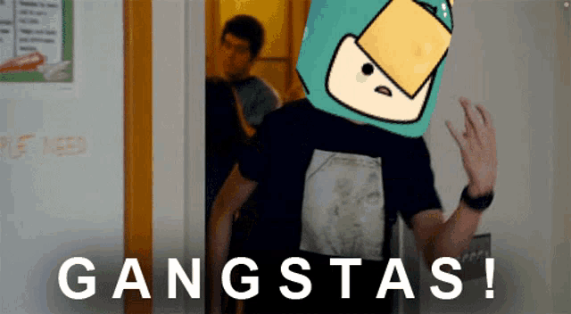 a man wearing a metallica shirt is standing in front of a wall that says gangstas