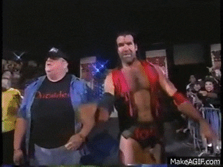 two men are walking in front of a crowd and one of them is wearing a shirt that says ' christian ' on it .
