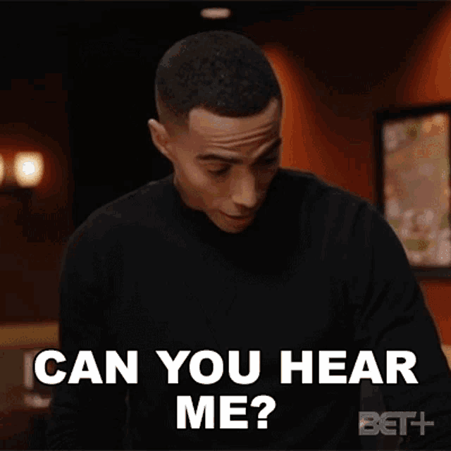 a man is sitting at a table and asking can you hear me ?