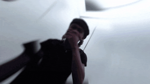 a blurry picture of a man talking on a phone