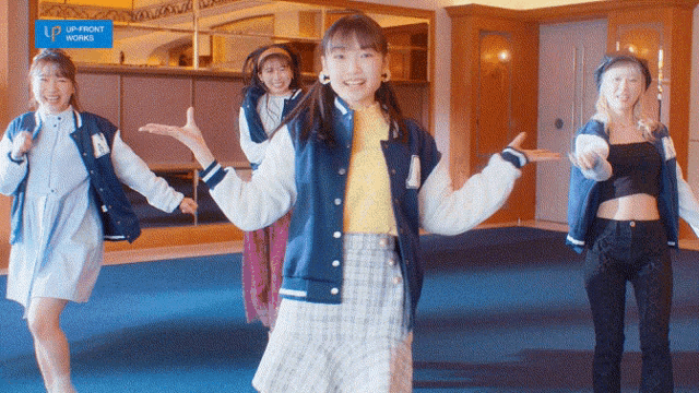 a group of girls are dancing in a room with a sign that says up front works