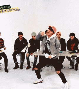 a group of young men are sitting around a table with a sign that says ' korean ' on it