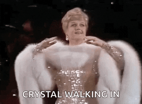 a woman is wearing a fur coat and a dress and says `` crystal walking in '' .