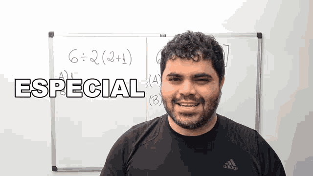 a man stands in front of a white board with the word especial written on it