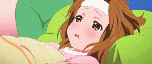 a girl with a bandage on her forehead is laying on a bed